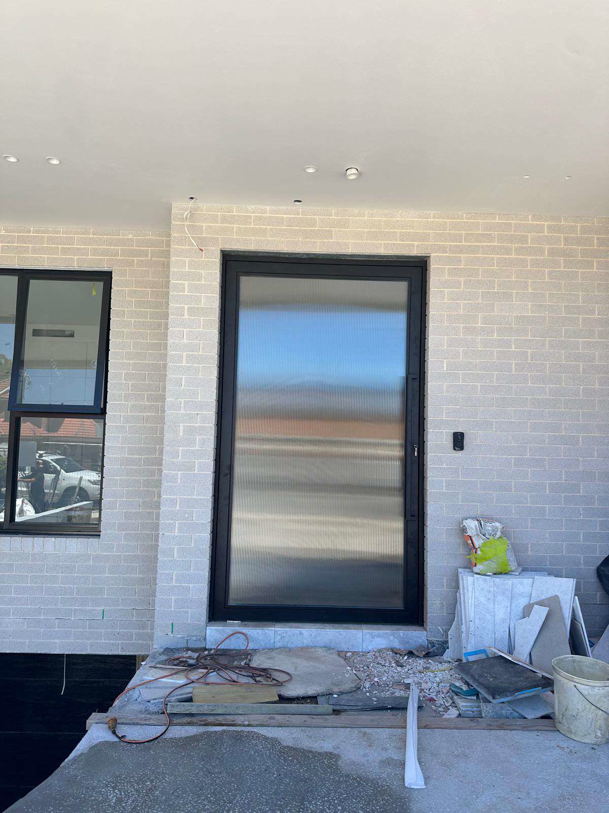 Glass entry door installed by Zenith Wright Pty Ltd on a new home