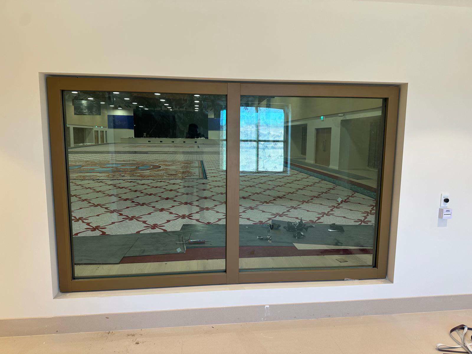 Aluminium sliding window glazing installed in a commercial building
