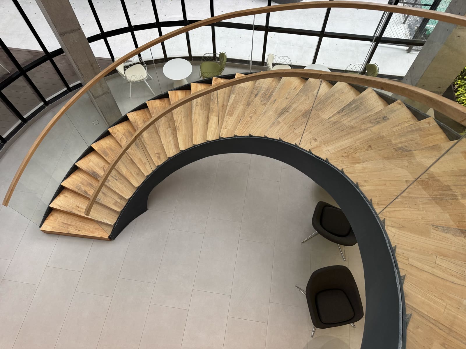 Spiral timber staircase with glass balustrade and handrail